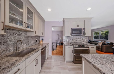 Fridge, microwave, oven, stovetop. Charming 3-bedroom modern family retreat!