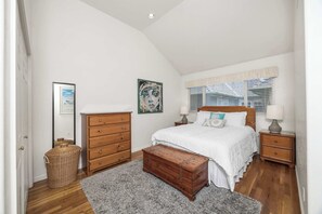 A bedroom with a bed, dresser, nightstand, and a large wooden chest. - Capitola Sea Winds one block to Capitola Beach (Capitola)