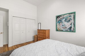A bedroom with a bed, a dresser, a wardrobe, and a painting on the wall. - Capitola Sea Winds one block to Capitola Beach (Capitola)