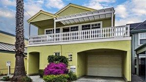 A two-story house with a balcony, a garage, and a small garden with purple flowers. - Capitola Sea Winds one block to Capitola Beach (Capitola)