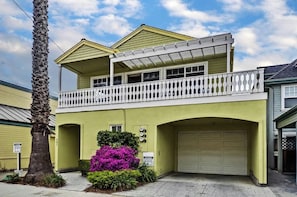 A two-story house with a balcony, a garage, and a small garden with purple flowers. - Capitola Sea Winds one block to Capitola Beach (Capitola)