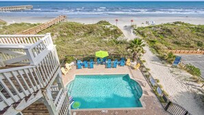 A pool with a view of the beach, a wooden deck, and lounge chairs. - Serenity is Yours! Oceanfront Pool,SP3 (North Myrtle Beach)