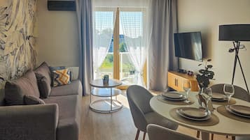 Superior Apartment | Living area | 50-inch Smart TV with cable channels