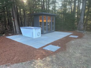 A small outdoor sauna with a glass enclosure and a large portable sauna unit beside it. - “Big Red” @ New London/Sunapee - Overflow Unit (New London)