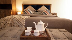 A neatly made bed with a headboard, a bedside table with a lamp, and a tray with tea set on a floral-patterned tray. - Perfectstayz Hills Rishikesh (Rishikesh)