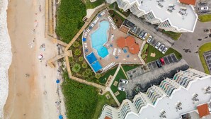 An aerial view of a resort with a swimming pool, beach, and multiple buildings. - Follow the Moon Villa, St Regis Oceanfront in Topsail (North Topsail Beach)