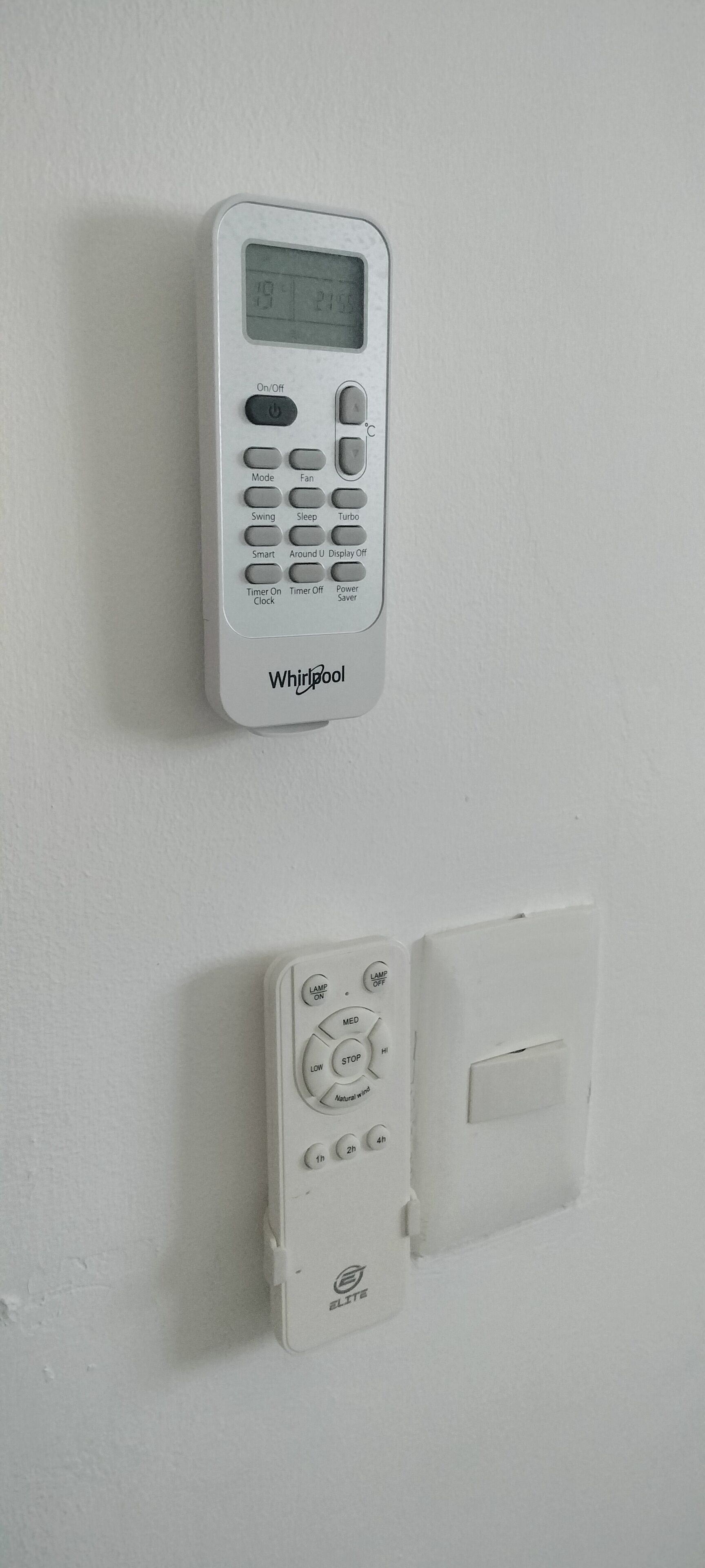 A wall-mounted Whirlpool thermostat and a BLITE light switch.