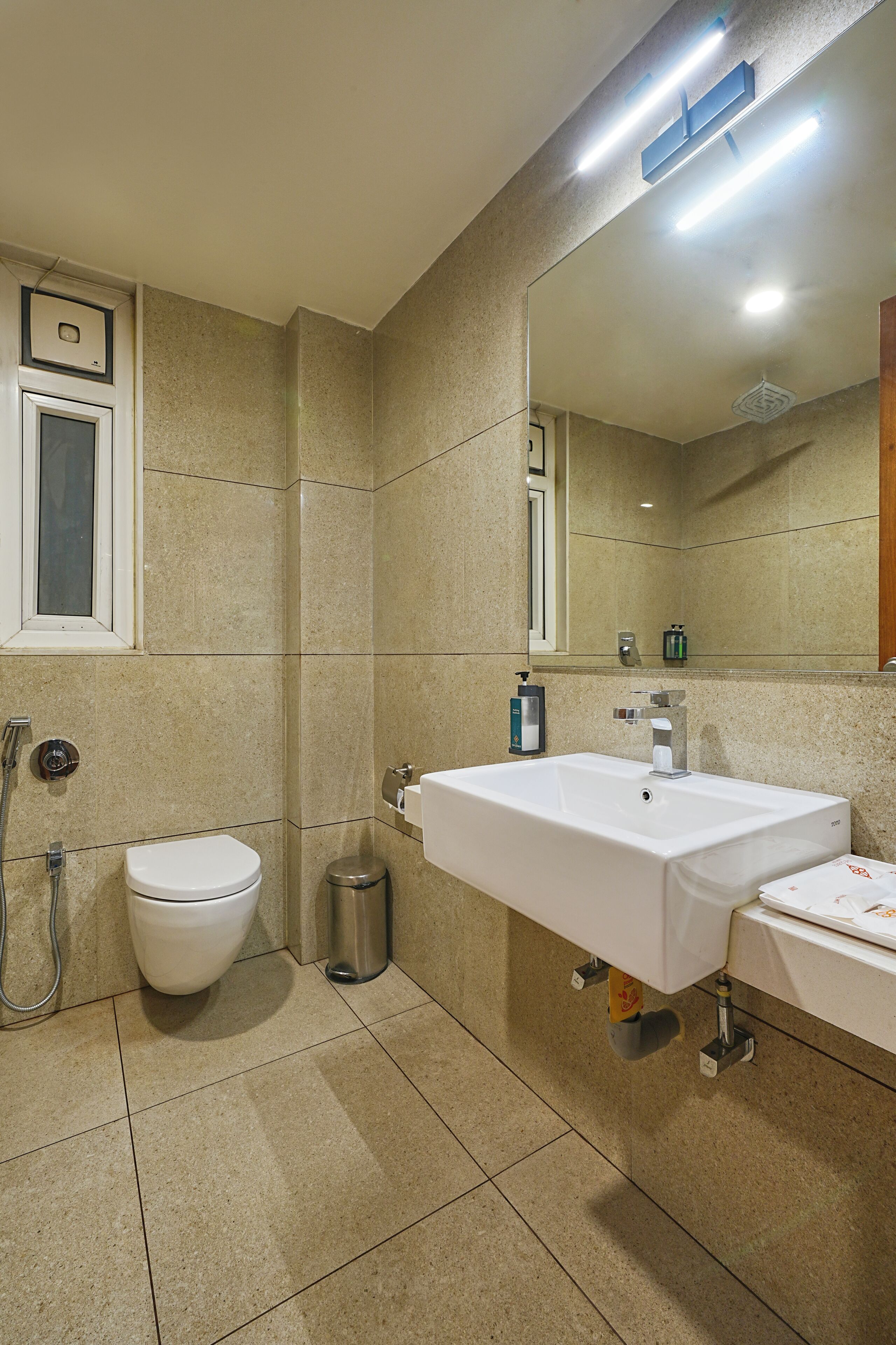 A bathroom with a toilet, sink, and shower.