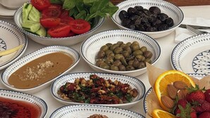 A table with various food items including cheese, fruits, nuts, and olives. - Kaia House (Mardin)