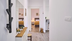 A modern hotel room with a wooden desk, a large mirror, and a bed with a headboard. - LAV Central Apartment by Litto (Split)