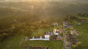 An aerial view of a residential area with houses, roads, and agricultural fields.
