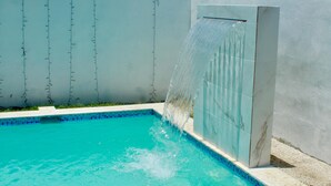 A swimming pool with a water feature.