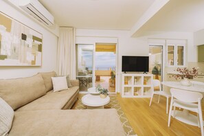 Apartment, Sea View | Living room | 55-inch Smart TV with satellite channels, Netflix, streaming services