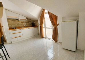 Fridge, stovetop, electric kettle, cookware/dishes/utensils
