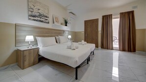 A hotel room with a large bed, two bedside tables, a headboard, and a view of the outdoors. - An amazing 3BR maisonette with private terrace &AC (Marsaskala)