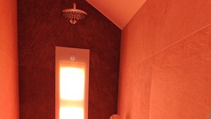 A shower with a glass door, a handheld showerhead, and a wall-mounted faucet. - Ultra-modern penthouse apartment (Brunnthal)