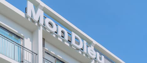 A hotel building with a prominent sign reading "Mon Dieu".