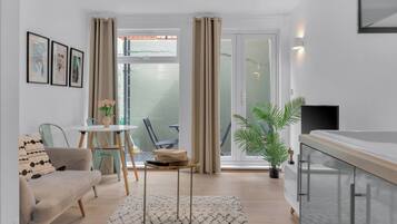 Standard Apartment | Living area | 26-inch TV with cable channels