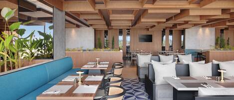En moderne restaurant med træbjælker i loftet, gulv med blå og hvide mønstre, og forskellige siddepladser inklusive båse og borde.