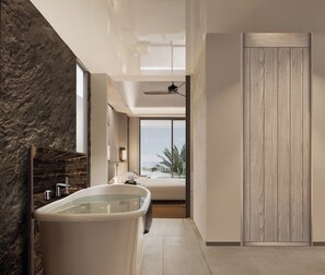 A modern bathroom with a freestanding bathtub, a large window with a view, and a wooden door. - Navera Phuket - Mgallery Collection (Choeng Thale)