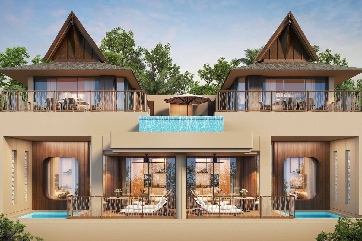 A modern hotel with two-story balconies, a swimming pool, and a view of the surrounding trees.