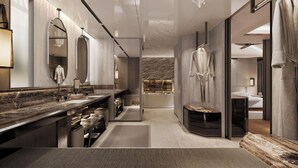 Un baño moderno con un espejo grande, dos lavamanos, un banco y una bañera.