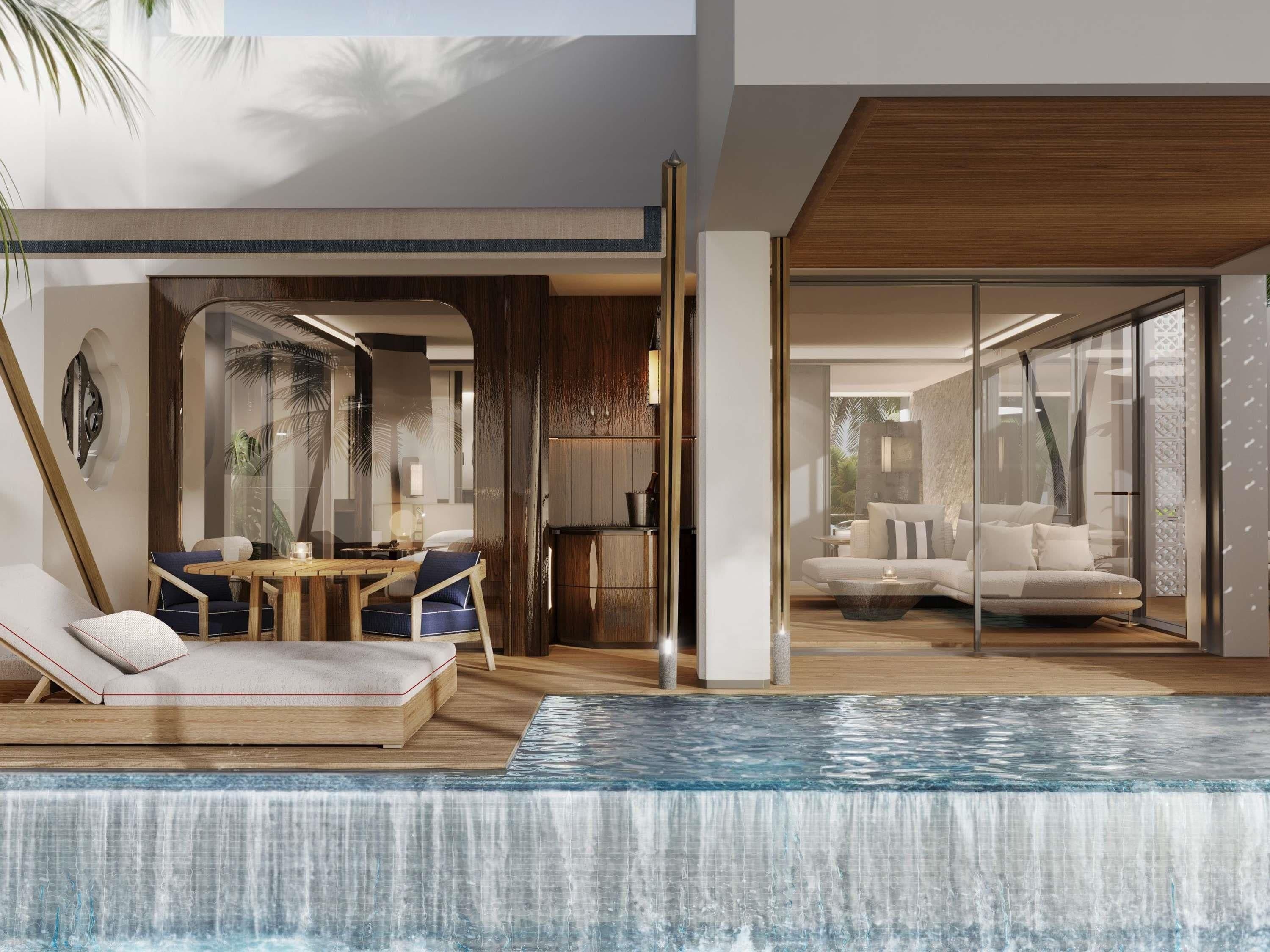 A modern indoor pool area with a glass-enclosed lounge, wooden furniture, and a view of the adjacent living area.
