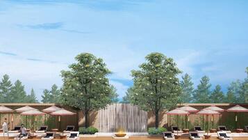 A poolside area with lounge chairs, umbrellas, and a waterfall.