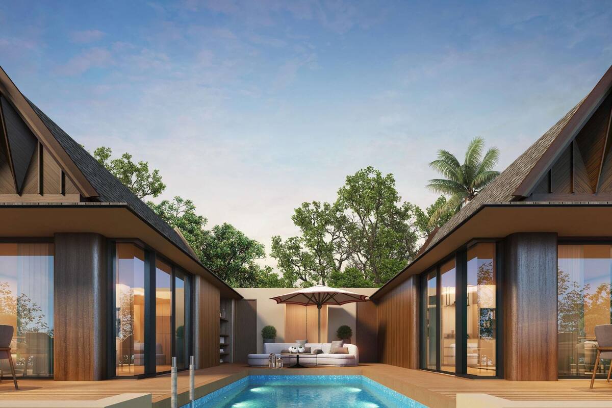 A modern outdoor pool area with a sofa and umbrella, surrounded by wooden walls and glass doors.