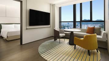 Junior Suite, 1 King Bed | Living area | 65-inch flat-screen TV with cable channels