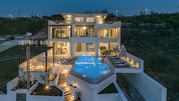 A modern two-story house with a swimming pool, outdoor seating, and a well-lit patio area. - Luxurious Villa Selestine - With Private Pool (Mylopotamos)