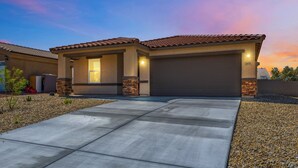 A modern two-story house with a tiled roof, a garage, and a driveway leading to the entrance. - New Build Close to River & Golf! (Fort Mohave)
