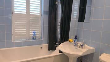 Separate bathtub and shower, deep-soaking bathtub, hair dryer, towels
