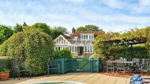 A house with a fenced backyard, a pool, and outdoor seating. - Little Forelands (Bembridge)