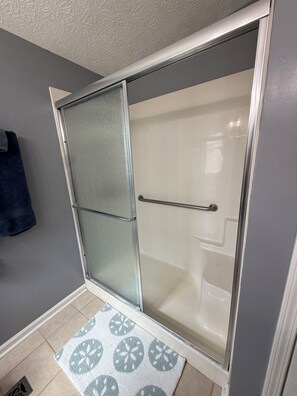 Shower, hair dryer, towels, toilet paper