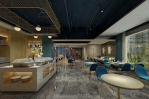 A modern restaurant with a marble floor, blue chairs, and a central serving area. - Manxin Hotel Beijing Jinsong Guangqumenwai Metro Station (Beijing)