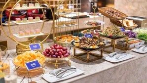 A buffet with various food items and utensils.