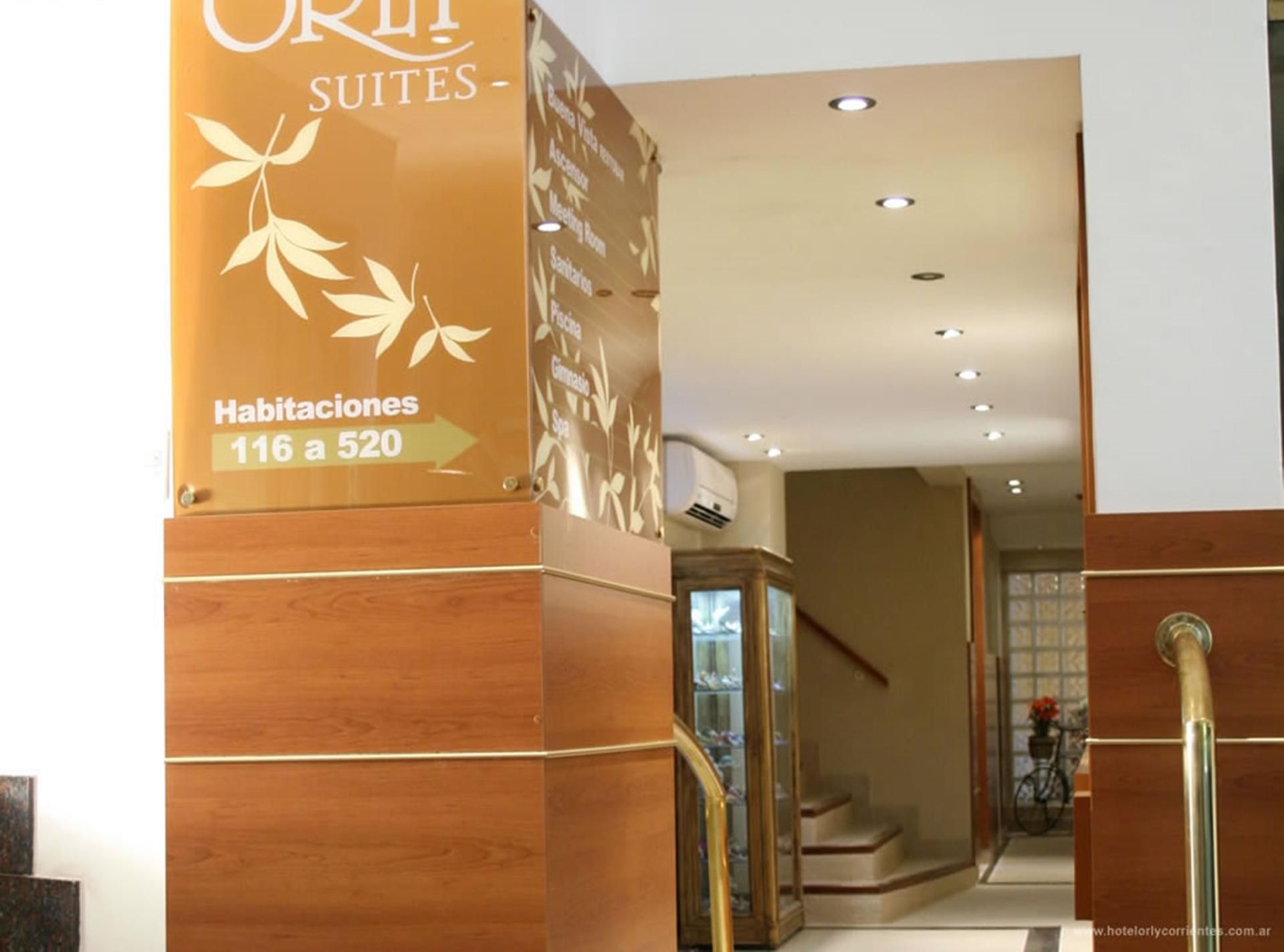 A hotel entrance with a sign indicating room numbers 116 to 520.