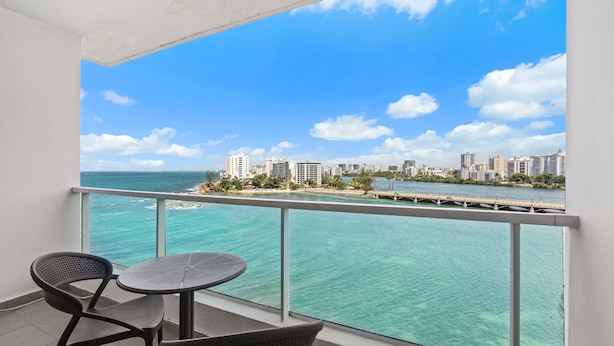 A balcony with a view of a city skyline and turquoise waters. - Ocean Front Old San Juan Private Terrace (San Juan)