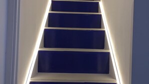 A staircase with illuminated handrails and steps.