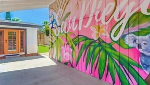A colorful mural with tropical plants and a koala on a wall. - Sunny Retreat Beaches Lakes Trails (La Mesa)