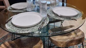 A dining area with a glass table set for four, surrounded by wooden chairs. - Sunny Loft Beaches Lakes Trails (La Mesa)