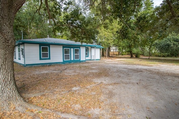 This cozy pet-friendly Gulfport home is nestled among lush greenery and offers a spacious private yard, perfect for your furry friends.