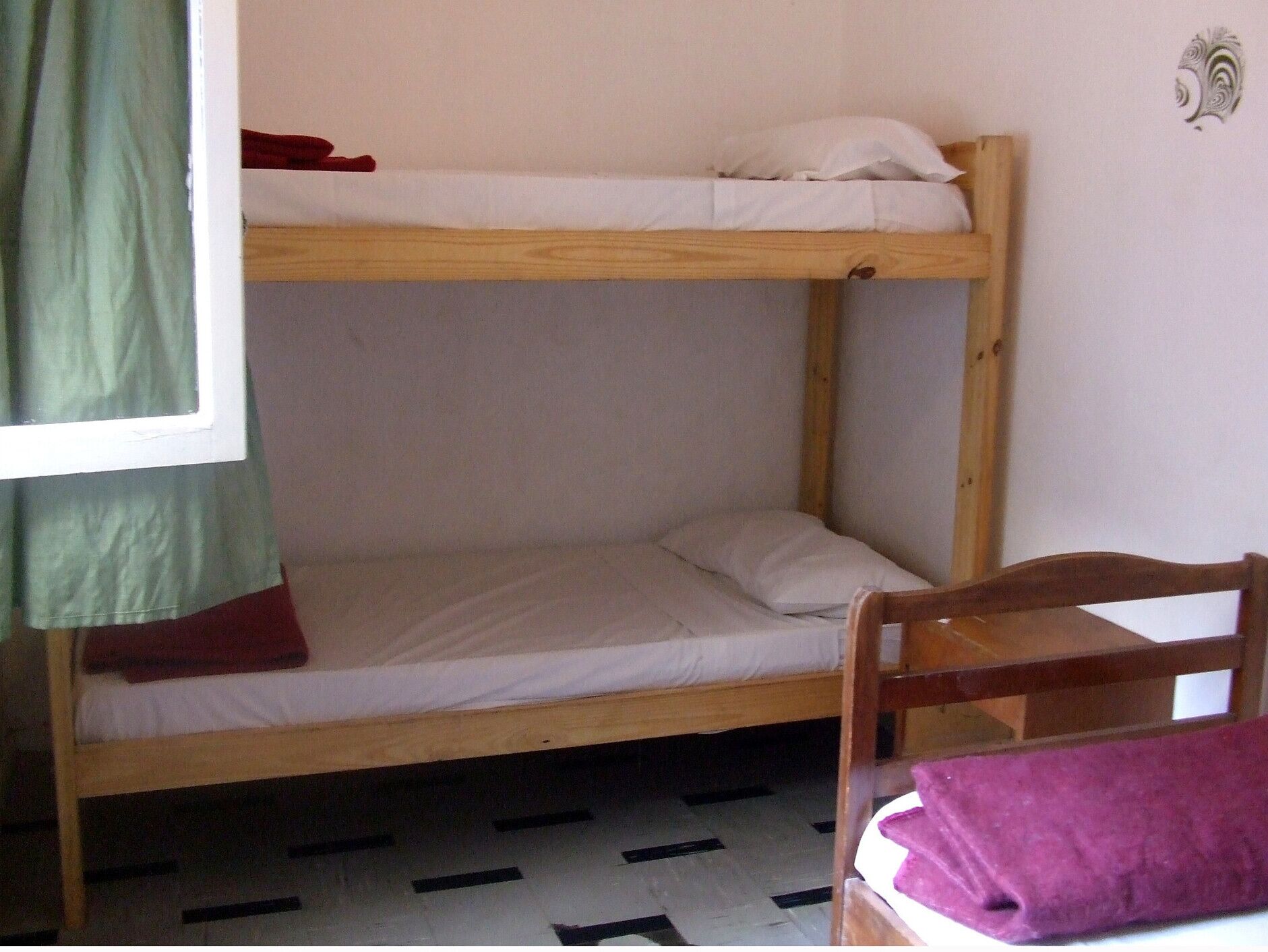 A bunk bed with a lower bunk and a single bed.