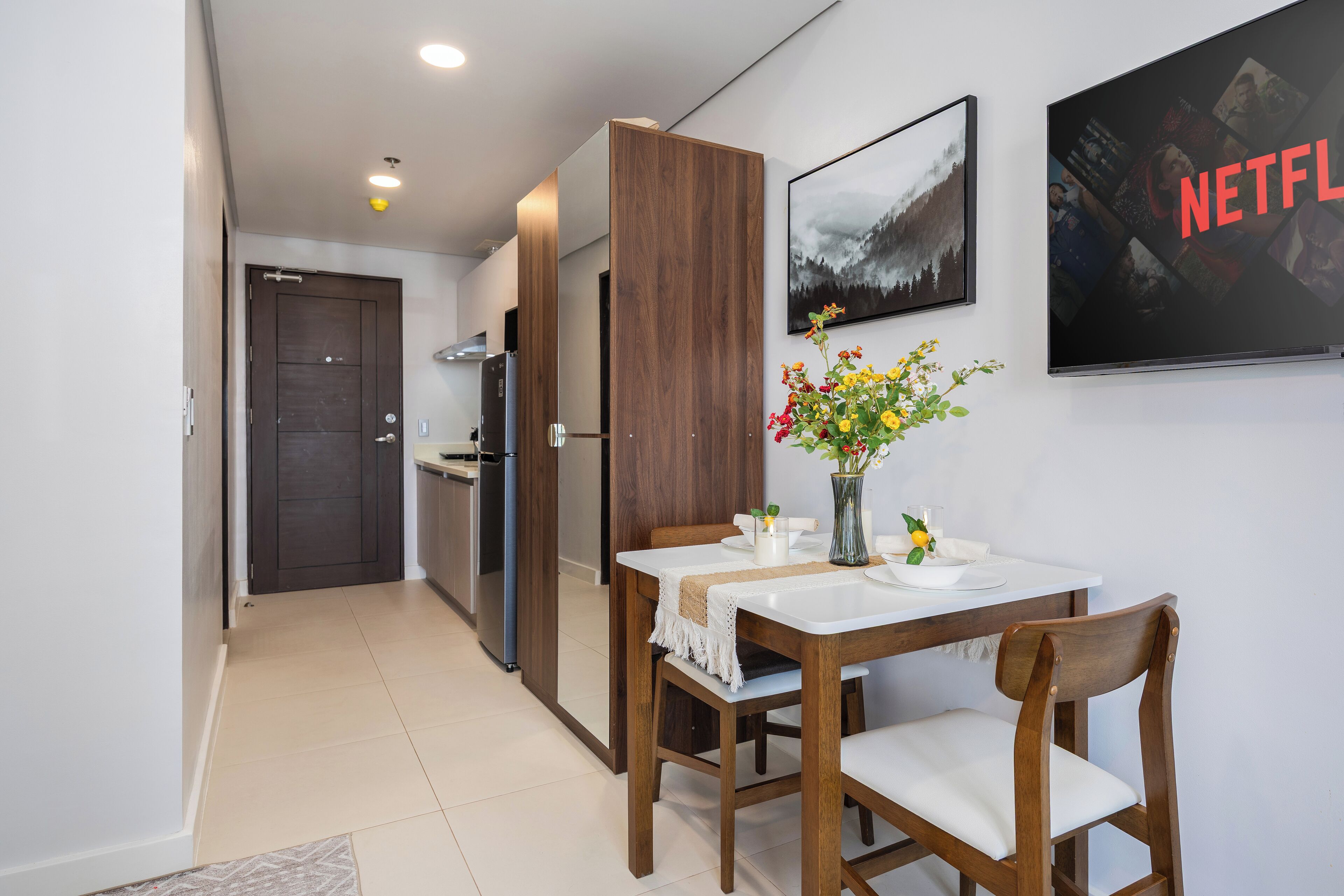 A modern kitchen with wooden cabinets and a white countertop.