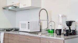 A kitchen with a microwave, sink, faucet, and coffee maker. - VH | Condesa nice loft with roof terrace + GYMNASIUM | 248 (Ciudad de México)