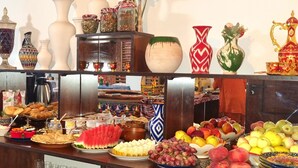A buffet table with various food items and decorative vases. - Oasis al Khiva Boutique Hotel Inside Citadel (Khiva)