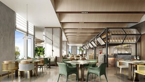 A spacious, modern restaurant with high ceilings, large windows, and a variety of seating arrangements including tables and chairs. - Holiday Inn Changchun High Tech Zone by IHG (Changchun)