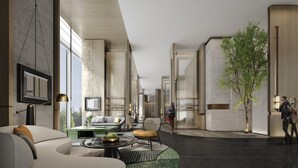 A modern interior with a sofa, a coffee table, and a chair. There is a large window and a tree outside. - Holiday Inn Changchun High Tech Zone by IHG (Changchun)