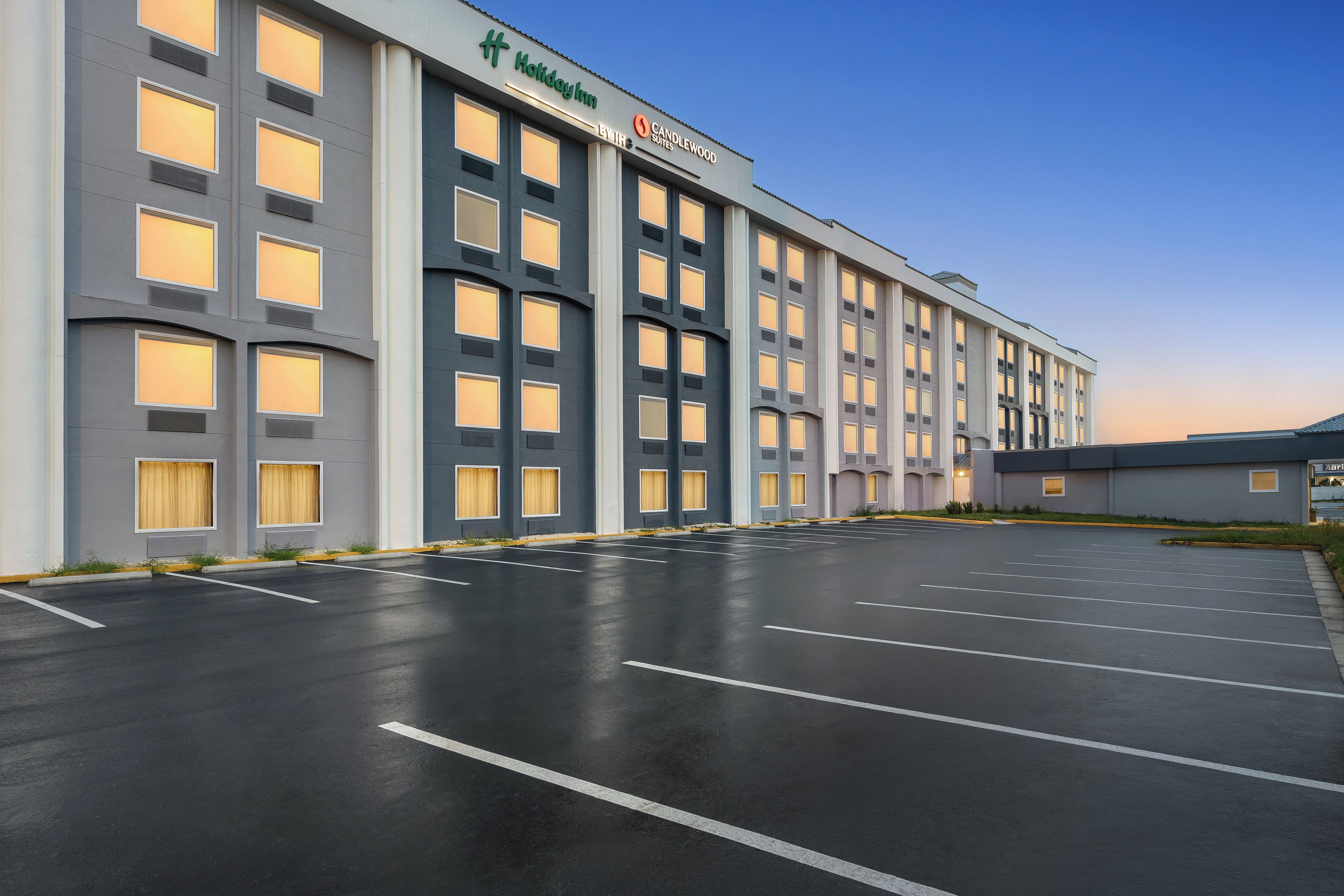Un hôtel Holiday Inn by Candlewood doté d’un grand parking et de plusieurs étages.